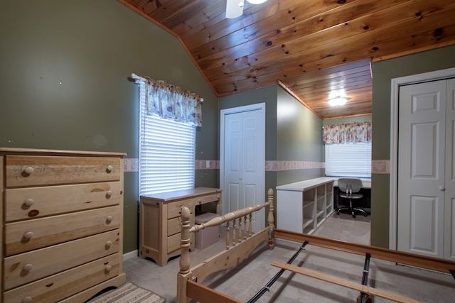 carpeted bedroom with wooden ceiling and lofted ceiling