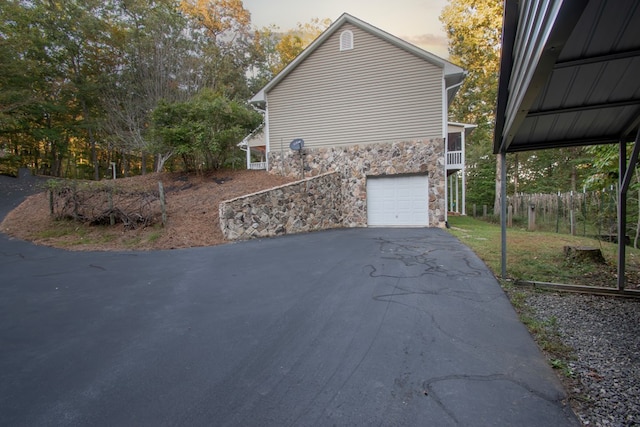 property exterior at dusk featuring a garage