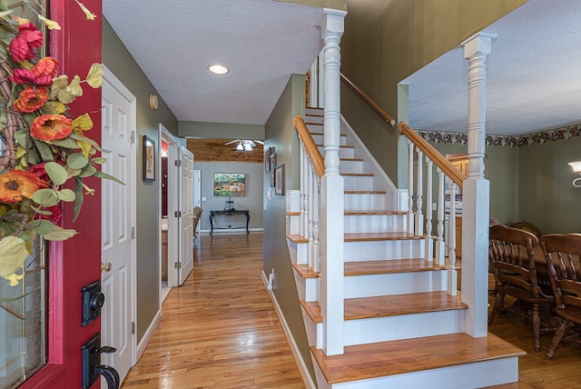 425 Tarheel Dr W, Murphy, NC 28906 - staircase featuring a textured ceiling, wood finished floors, baseboards, and recessed lighting
