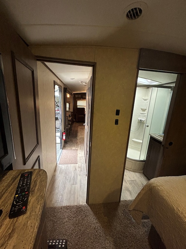 hallway with light hardwood / wood-style flooring