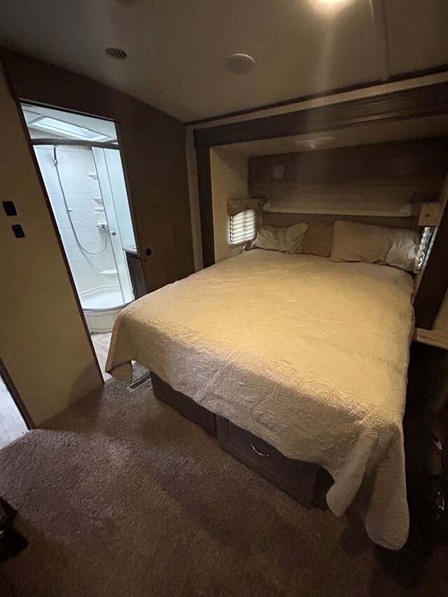 carpeted bedroom with connected bathroom