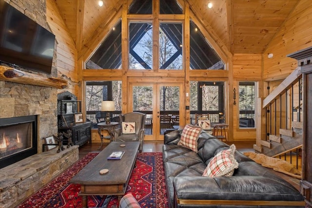 510 Gallery Ct, Ellijay, GA 30540 - living area featuring high vaulted ceiling, plenty of natural light, wooden ceiling, stairway, and a stone fireplace