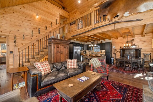 510 Gallery Ct, Ellijay, GA 30540 - living area with wood walls, hardwood / wood-style flooring, a chandelier, a wood ceiling with exposed beams, and a high ceiling