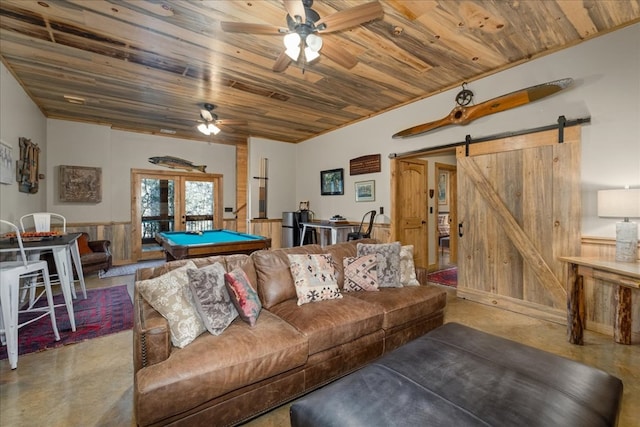 510 Gallery Ct, Ellijay, GA 30540 - living room featuring finished concrete flooring, wooden ceiling, a barn door, a ceiling fan, and a wainscoted wall
