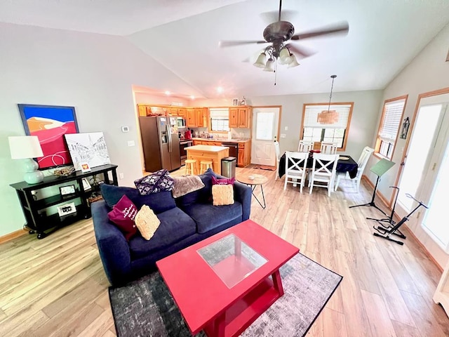 384 Shadow Pines Dr, Murphy, NC 28906 - living room featuring lofted ceiling, plenty of natural light, light wood-style flooring, a ceiling fan, and baseboards