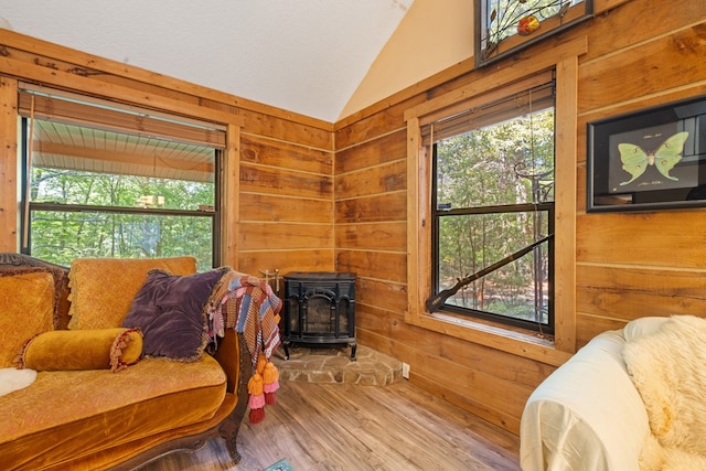 881 Sawyer Cove Rd, Hayesville, NC 28904 - sitting room featuring lofted ceiling, a wood stove, wood walls, plenty of natural light, and wood finished floors