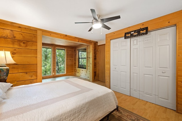 881 Sawyer Cove Rd, Hayesville, NC 28904 - bedroom with wood walls, light wood finished floors, a closet, and ceiling fan