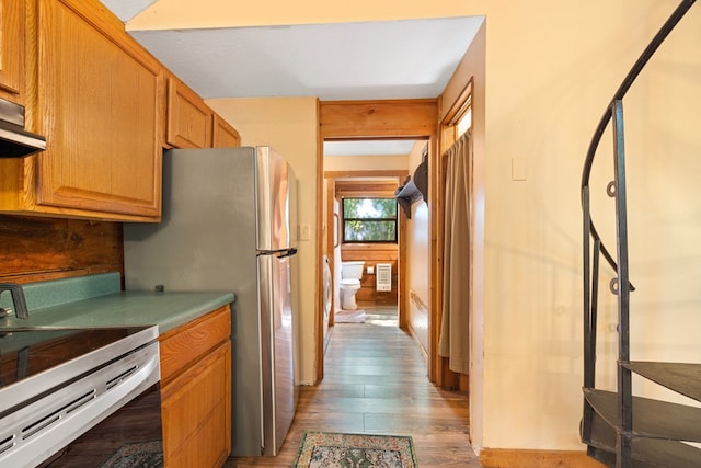 881 Sawyer Cove Rd, Hayesville, NC 28904 - kitchen featuring stainless steel appliances, wood finished floors, brown cabinetry, and extractor fan