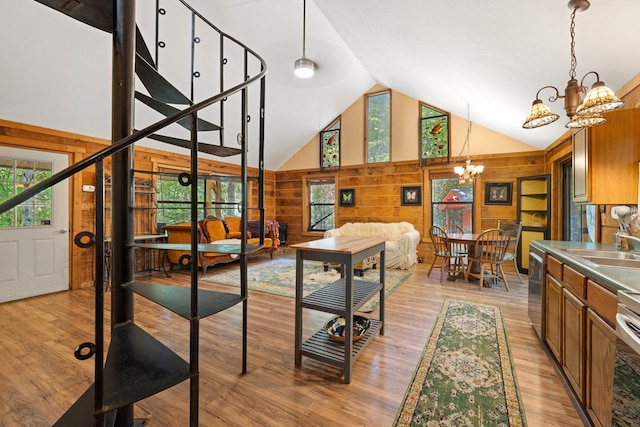 881 Sawyer Cove Rd, Hayesville, NC 28904 - dining space featuring wood walls, a chandelier, high vaulted ceiling, plenty of natural light, and light wood-style flooring