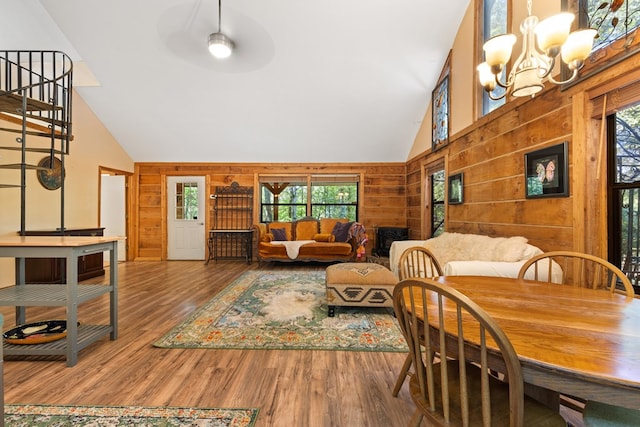 881 Sawyer Cove Rd, Hayesville, NC 28904 - dining area with wood walls, a chandelier, plenty of natural light, high vaulted ceiling, and wood finished floors