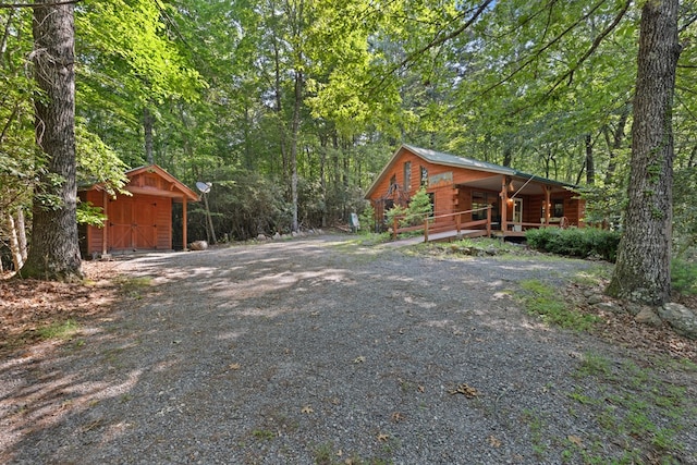 881 Sawyer Cove Rd, Hayesville, NC 28904 - view of side of property with a storage shed, driveway, and a wooded view