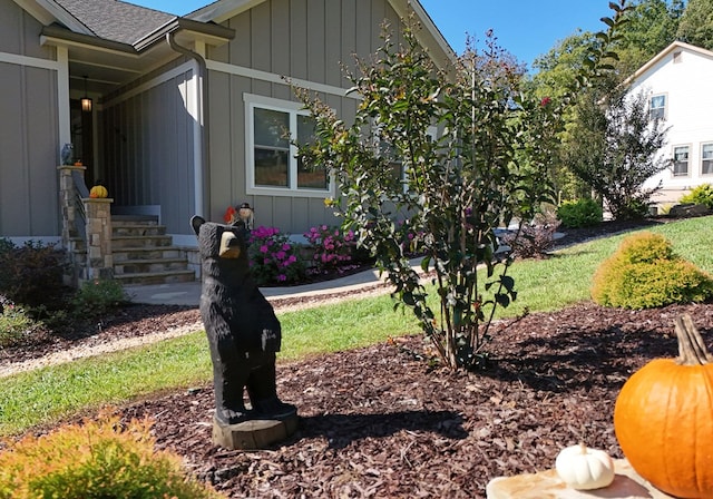 view of side of property with a yard