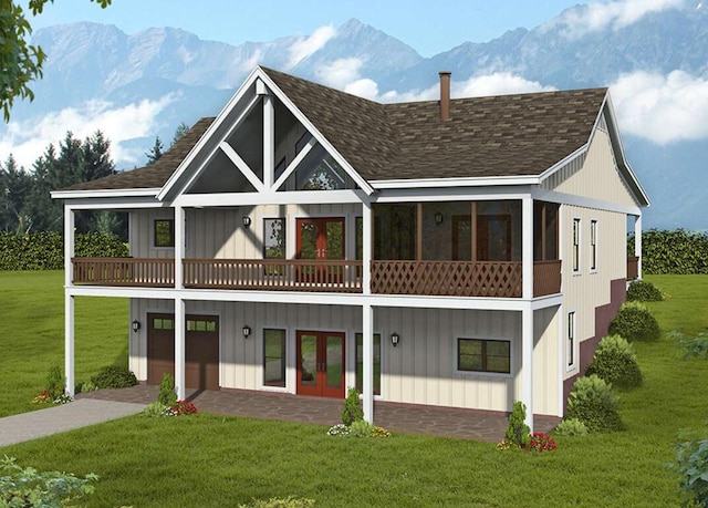 rear view of house with a mountain view, french doors, a yard, and a balcony