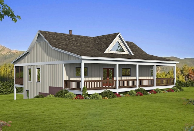 rear view of house with a lawn and a mountain view