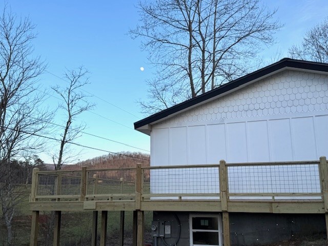 view of side of home featuring a wooden deck