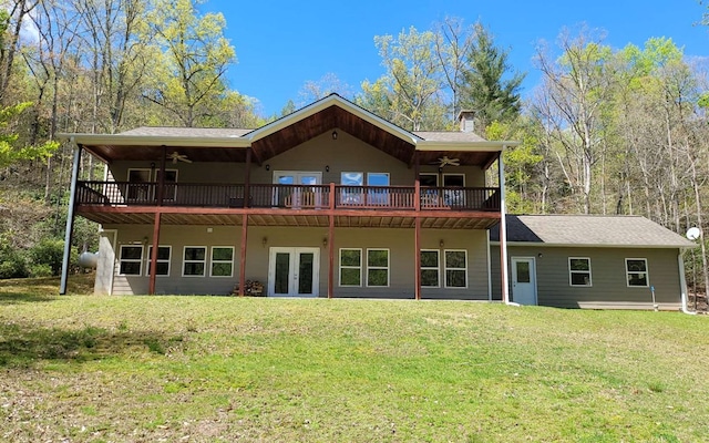 back of property featuring french doors, a yard, and ceiling fan