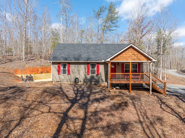 view of front of home with roof with shingles and stairs