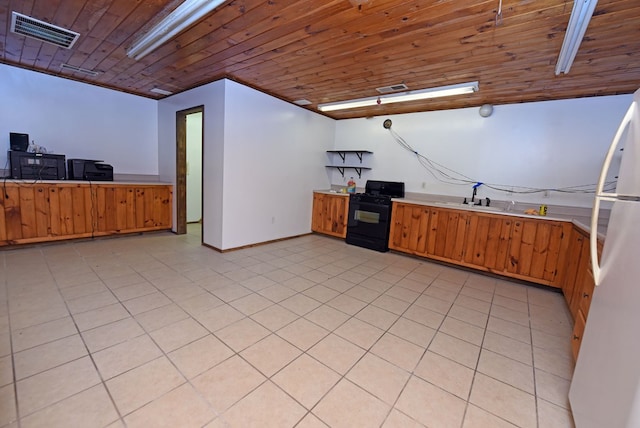 kitchen featuring sink, black range with gas stovetop, white refrigerator, light tile patterned floors, and wood ceiling