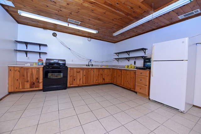 kitchen with black gas range, white refrigerator, light tile patterned flooring, and wooden ceiling