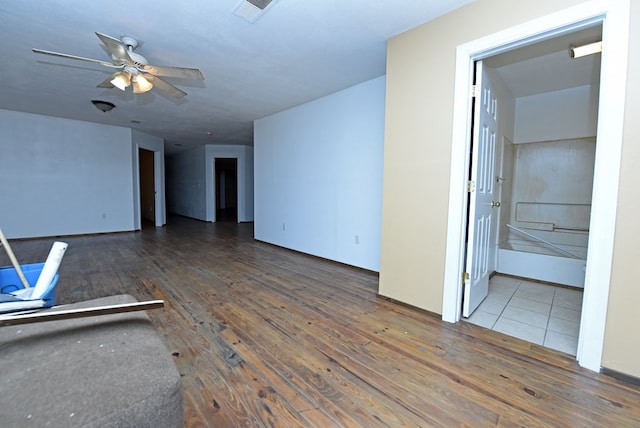 unfurnished living room with ceiling fan and dark hardwood / wood-style floors