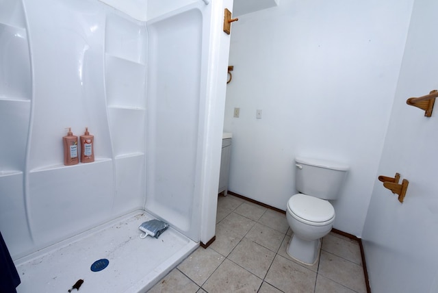 bathroom featuring toilet, tile patterned flooring, and walk in shower