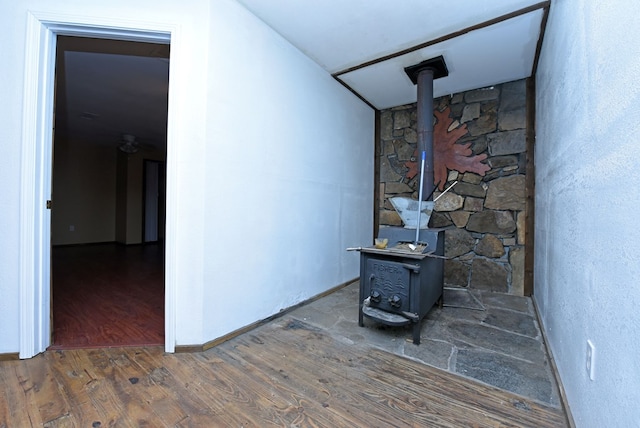 interior space featuring wood-type flooring and a wood stove