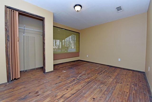 unfurnished bedroom featuring a closet and wood-type flooring