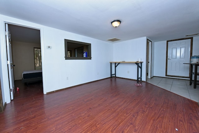 unfurnished living room with dark hardwood / wood-style flooring