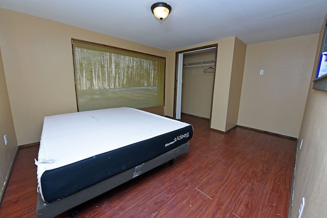 bedroom featuring dark hardwood / wood-style floors and a closet