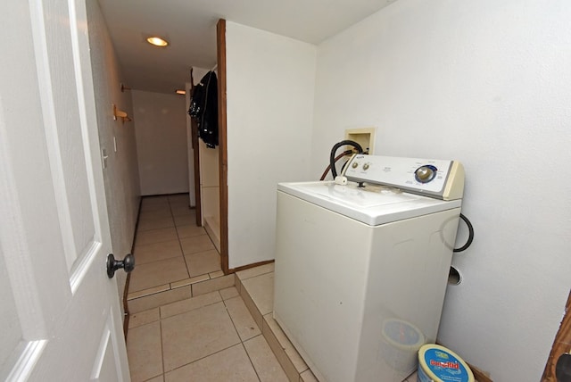 clothes washing area featuring washer / dryer and light tile patterned floors