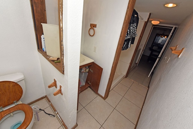 bathroom with tile patterned floors, vanity, and toilet