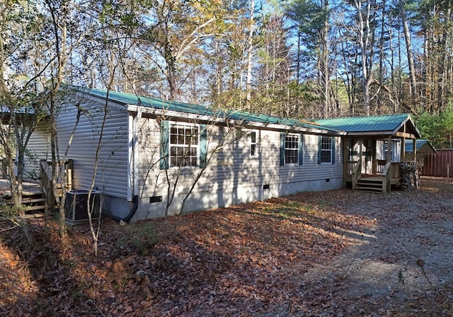 view of front facade with a wooden deck and central AC