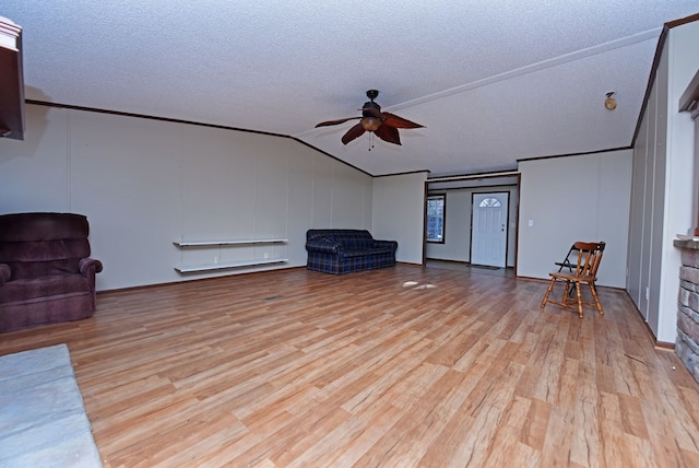 unfurnished room with ceiling fan, light hardwood / wood-style floors, a textured ceiling, and vaulted ceiling