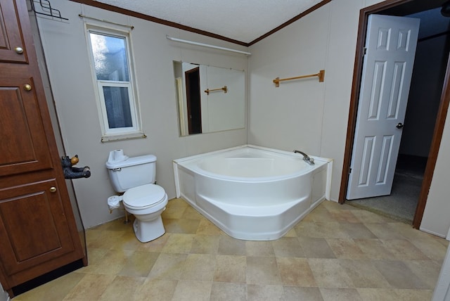 bathroom with a washtub, a textured ceiling, toilet, and ornamental molding