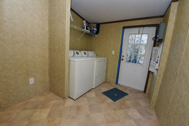 washroom featuring washer and dryer, a textured ceiling, and crown molding