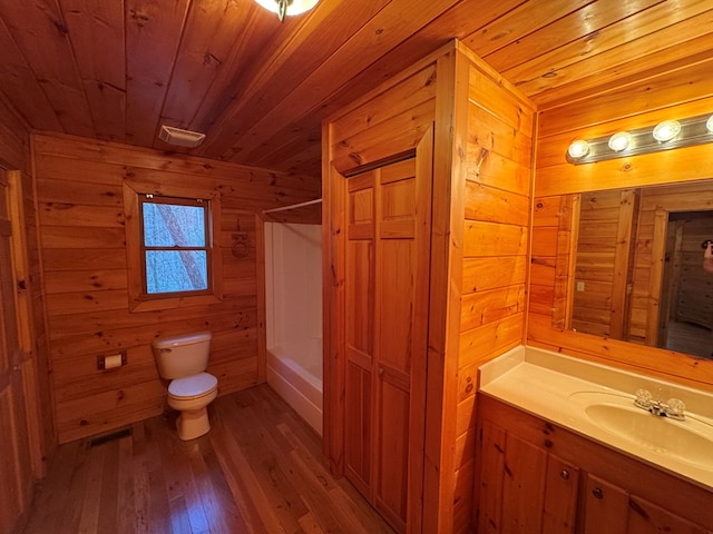 bathroom with toilet, wood ceiling, wood finished floors, and vanity