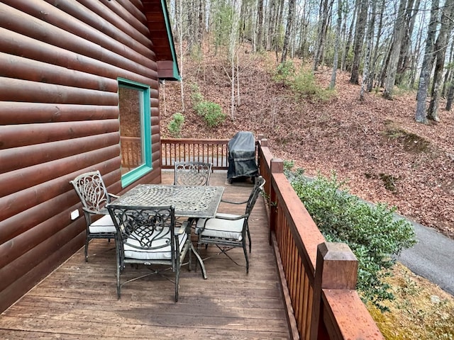 deck with area for grilling and outdoor dining area