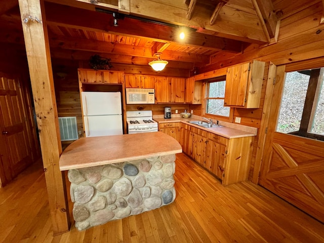 kitchen featuring light wood-type flooring, beamed ceiling, a sink, white appliances, and light countertops