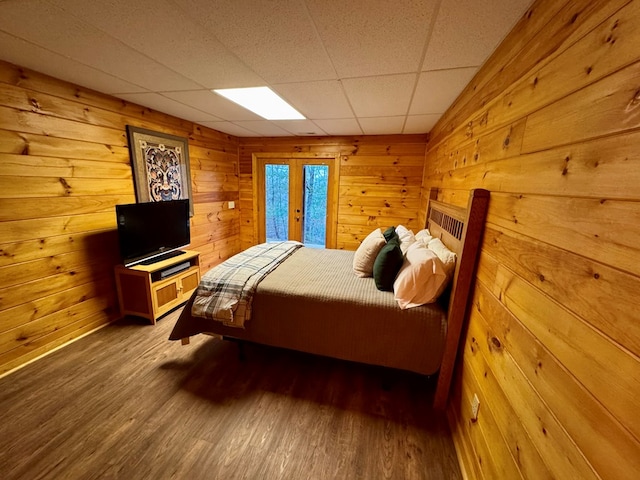 bedroom featuring wooden walls and wood finished floors