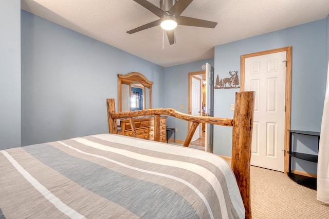 bedroom with ceiling fan, a textured ceiling, and light colored carpet