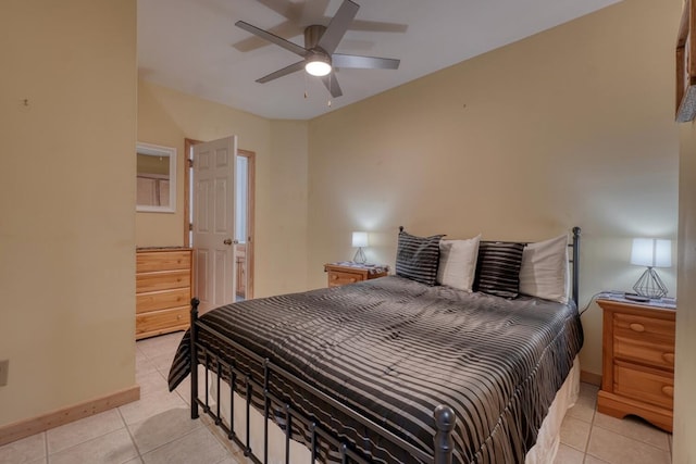 bedroom with light tile patterned floors, a ceiling fan, and baseboards