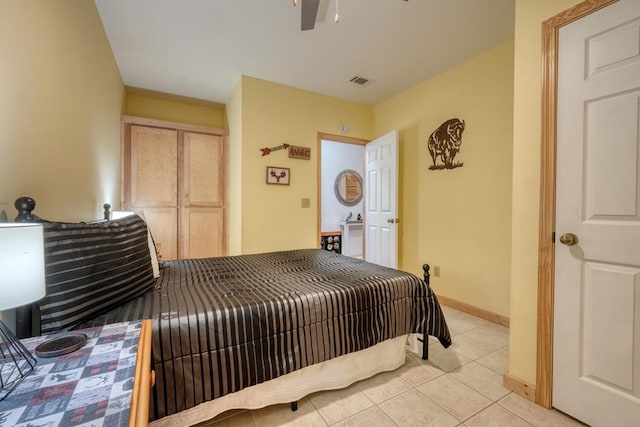 bedroom with visible vents, baseboards, and light tile patterned floors