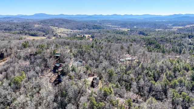 aerial view with a mountain view and a wooded view