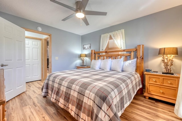 bedroom with light wood-type flooring and a ceiling fan