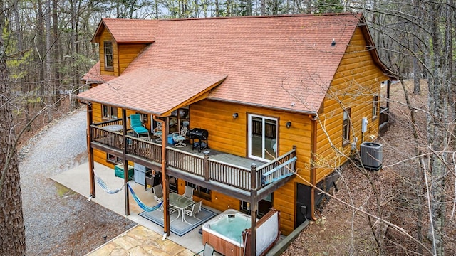 2487 Newport Dr, Ellijay, GA 30540 - rear view of property featuring roof with shingles, a deck, a hot tub, and central AC