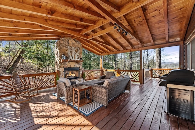 wooden deck featuring an outdoor living space with a fireplace