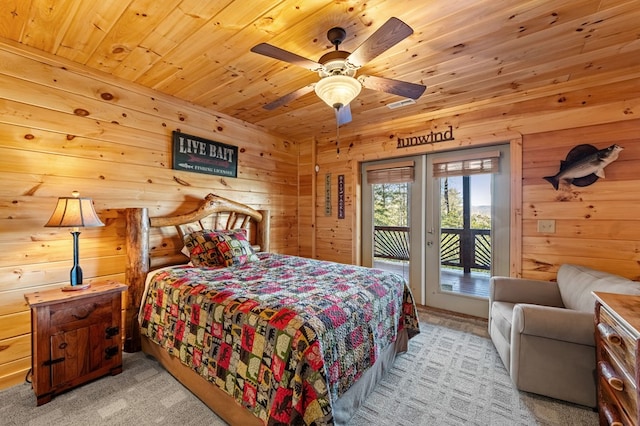 bedroom featuring access to exterior, wood ceiling, wooden walls, and light colored carpet