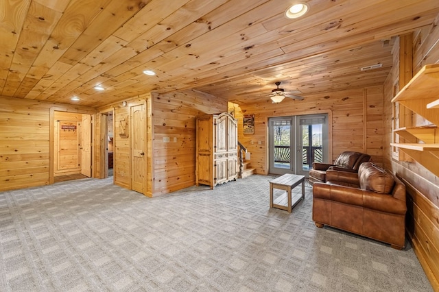 living room with light colored carpet, wooden ceiling, and wood walls