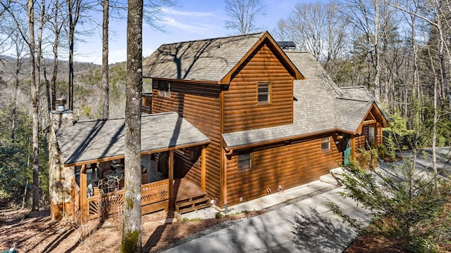 log cabin featuring covered porch