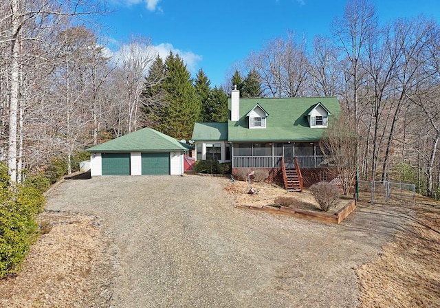 view of front facade with an outbuilding, a porch, and a garage